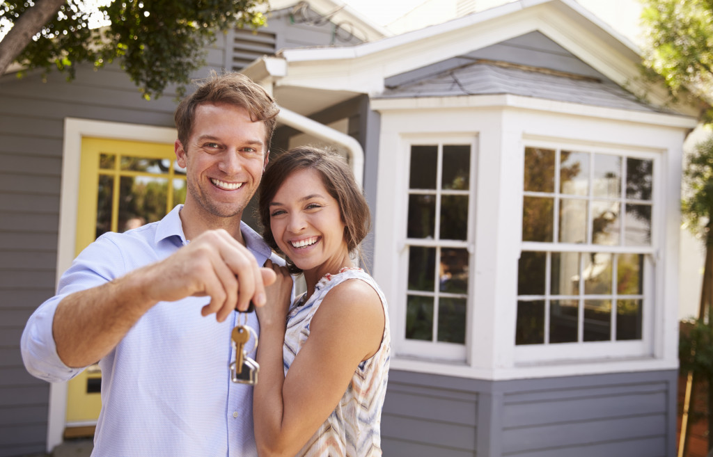 Couple holding keys to new house