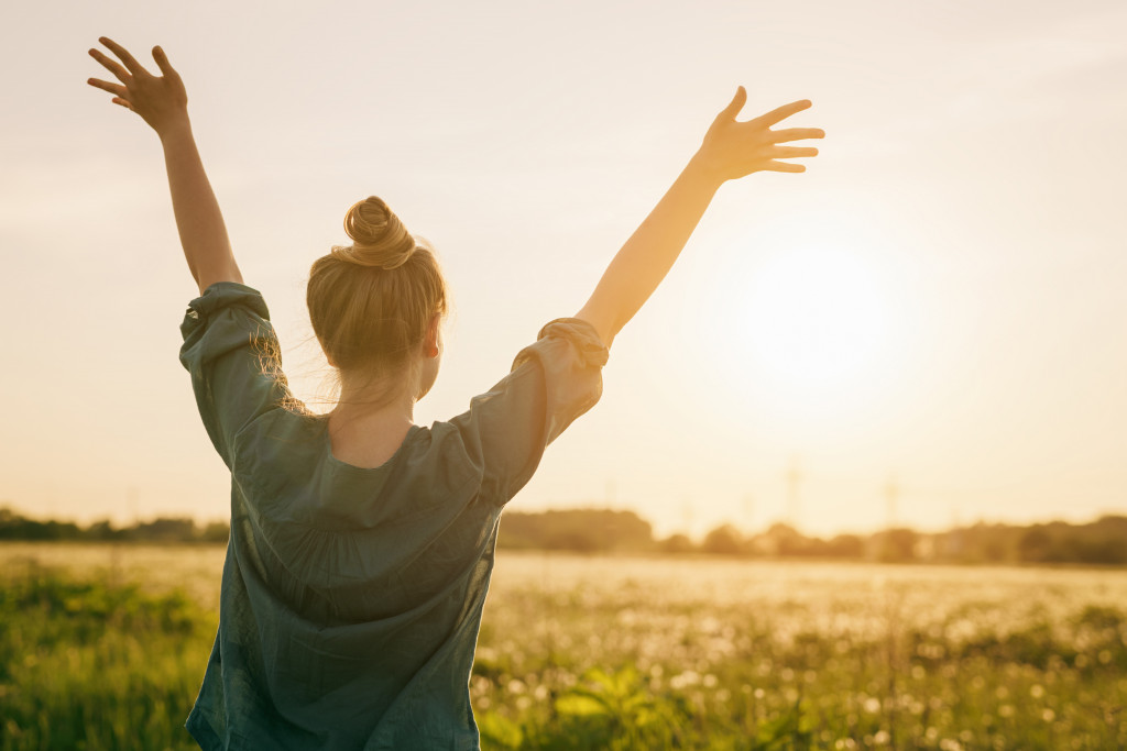 independent woman raising her hands