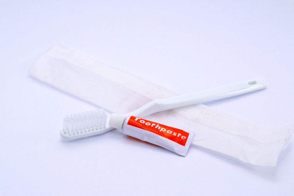 A travel toothbrush and toothpaste from a hotel