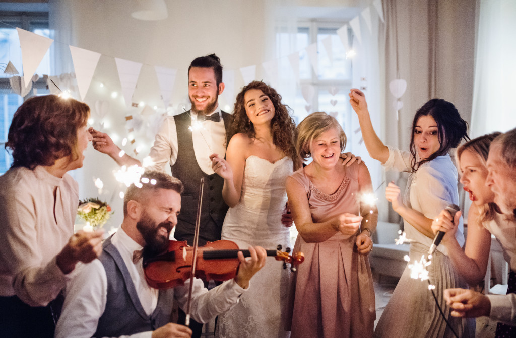 a wedding party with violinist and guests having fun
