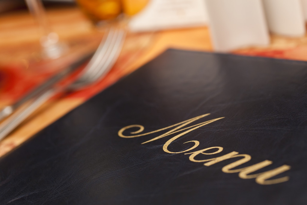 A black menu on a restaurant table