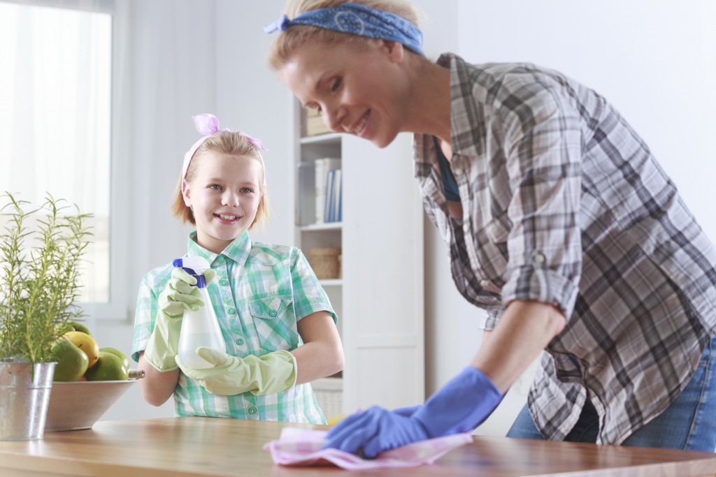 in the kitchen and her daughter cleaning